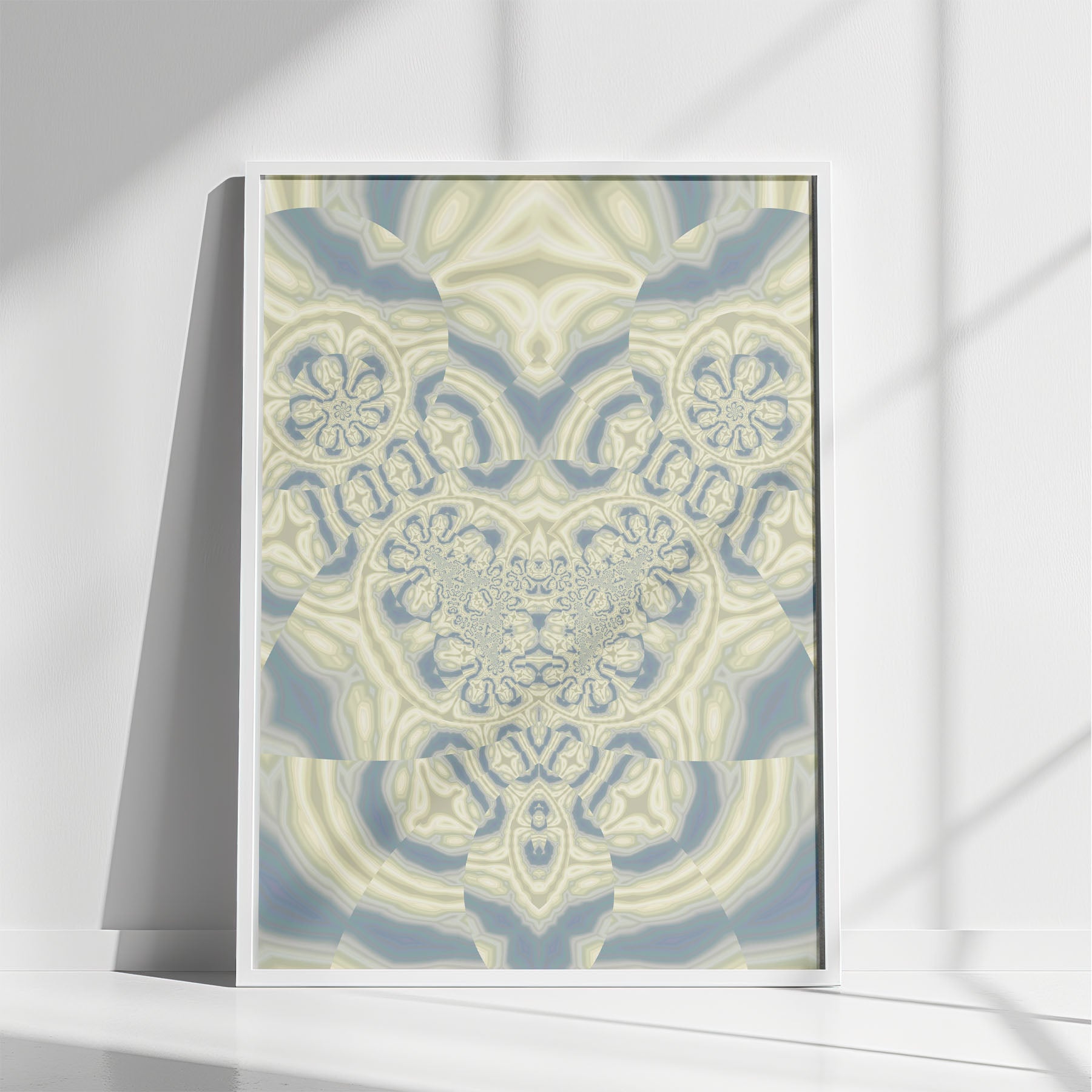 Angelus abstract fractal artwork featuring soft blue, sage green, and cream symmetric patterns in a black frame.